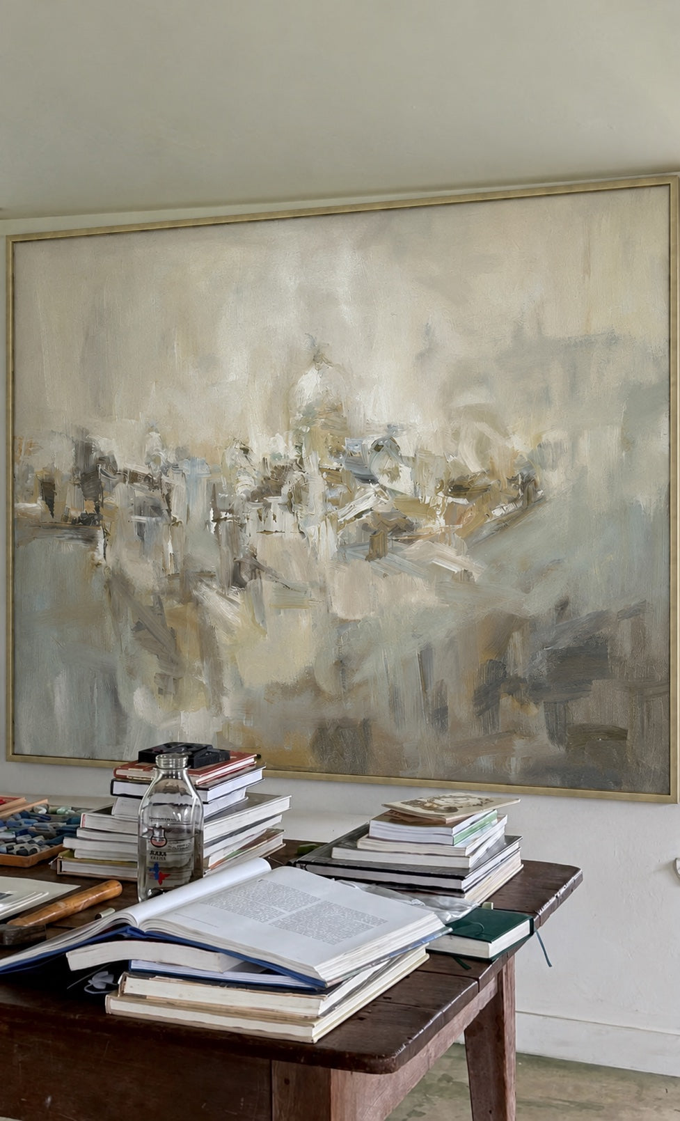 Closer view of Abstract Village above books on a worktable