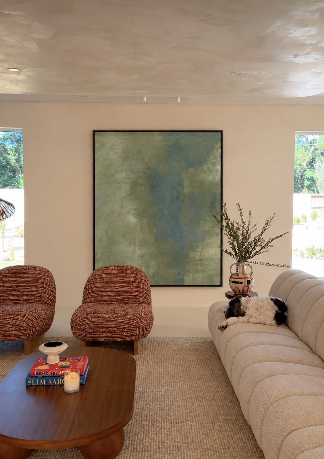 Study of Green in a living room with rust-red chairs and a white sofa